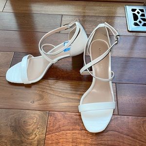 Strappy, white, open-toed heels, made by Kate and Katie. Women’s size 7